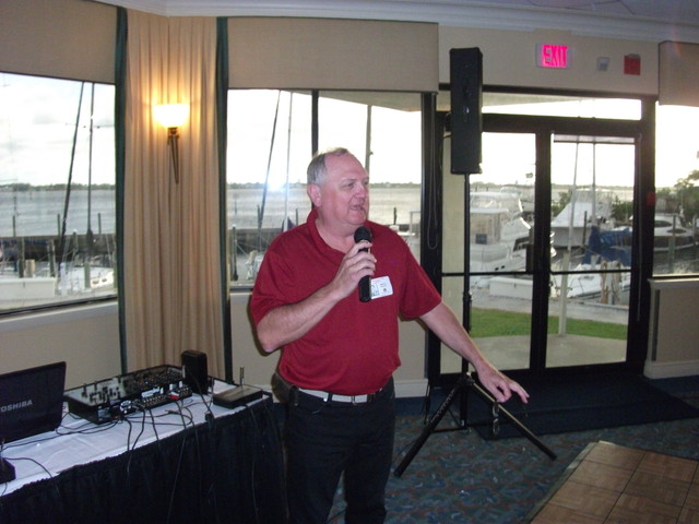Our DJ for Saturday evening, Doug Crouse, addresses the group with the beautiful Manatee River as a backdrop