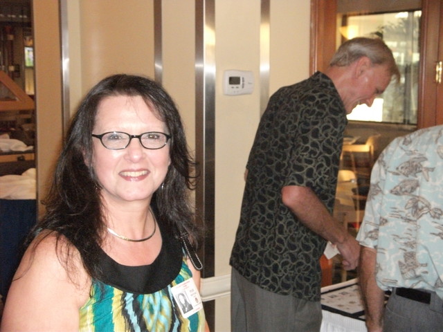 Pam Mefferd Russ looking lovely while Lee Cool checks out the name badges in background