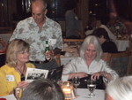 Shelley Knight Eisner and Glenn Markos look at something while Debbie Reichert Weathers looks for something