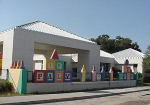 Photo of Palmetto Elementary as seen from the alleyway showing Kindergarten Play Area and Crayon Wall