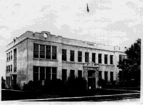 Photograph of white concrete school building